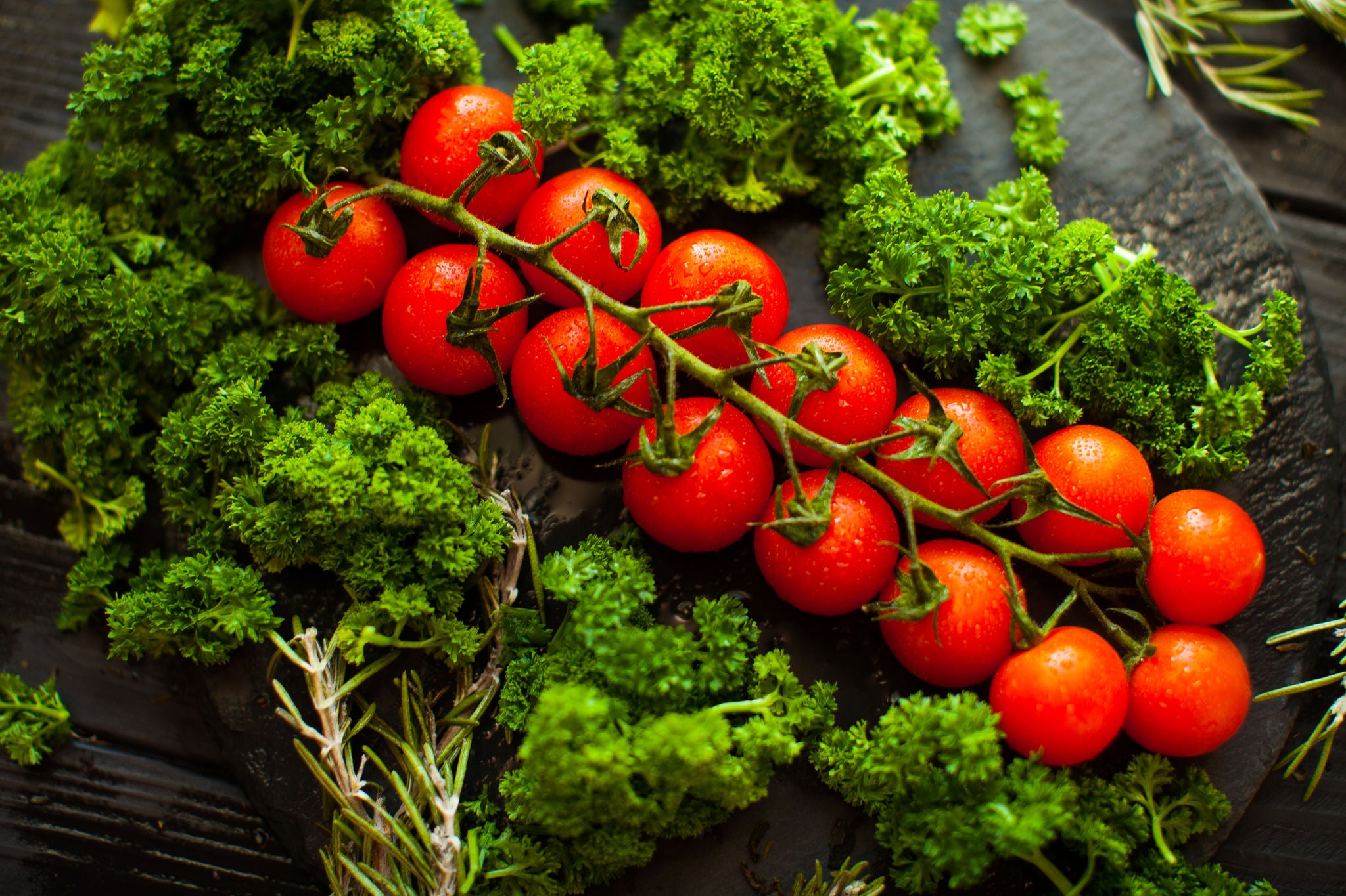 Fresh Cherry Tomatoes and Kale on Rustic Slate
