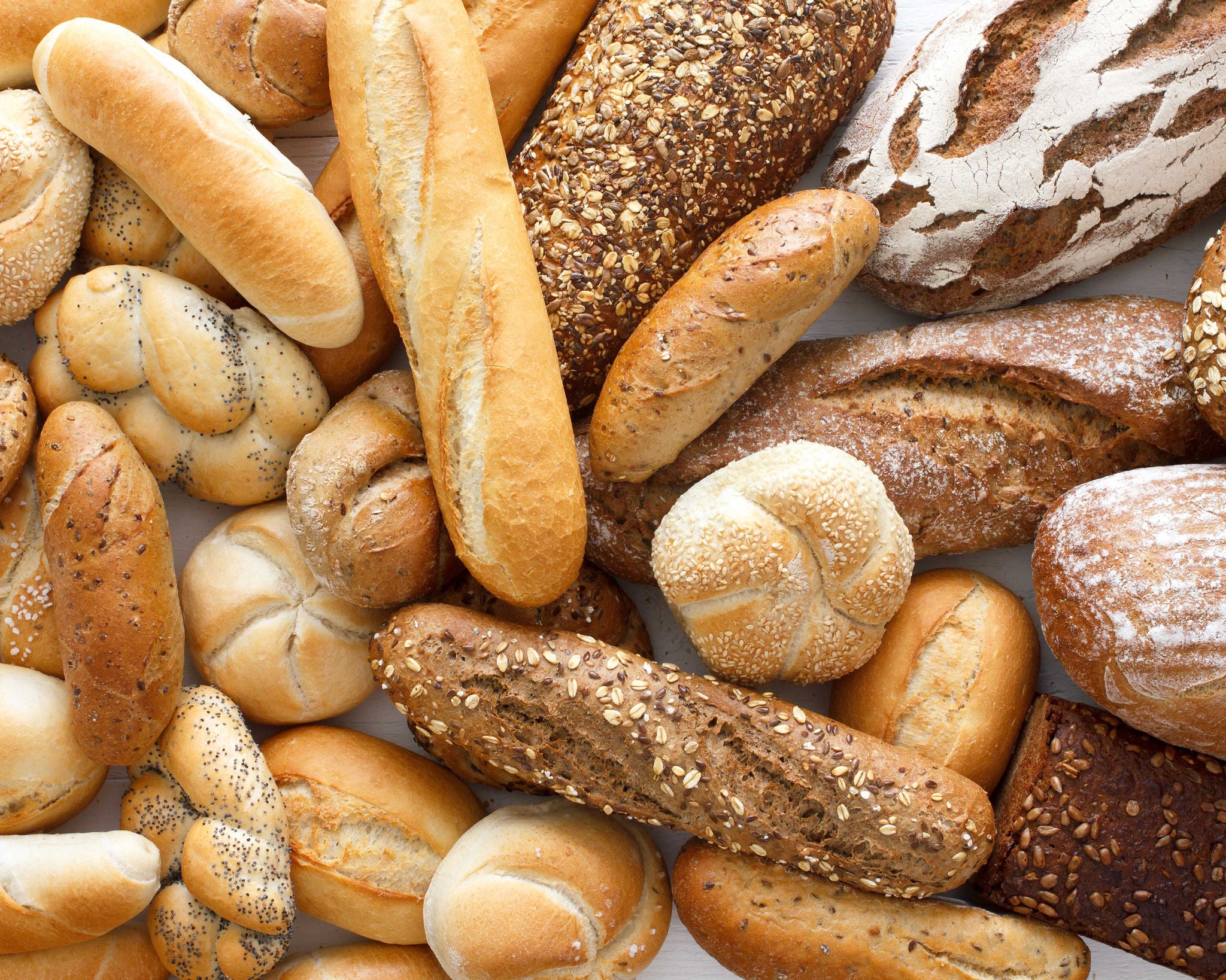 Assorted Fresh Breads Variety Displayed on Table