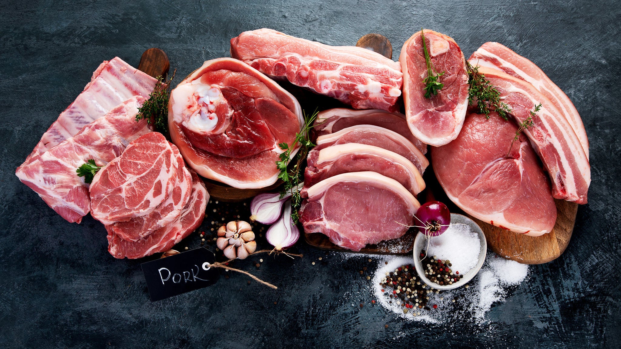 Different types of raw meat on black background. Foods high in protein. Top view, flat lay