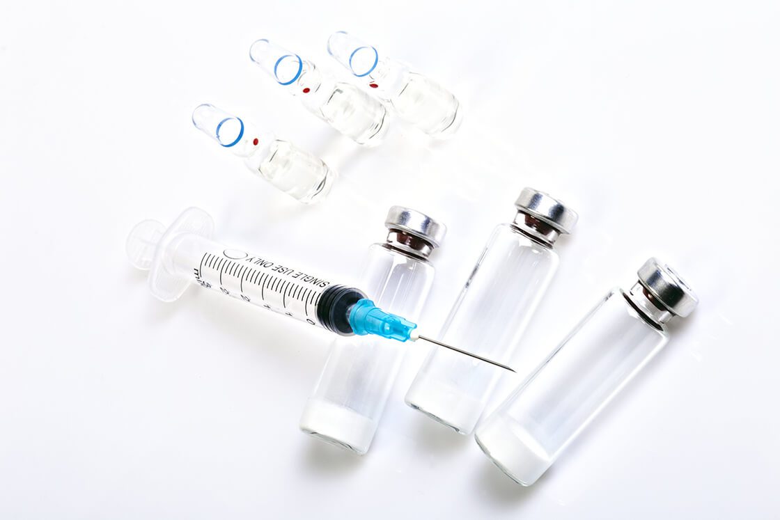 Medical Syringe and Vials on White Background
