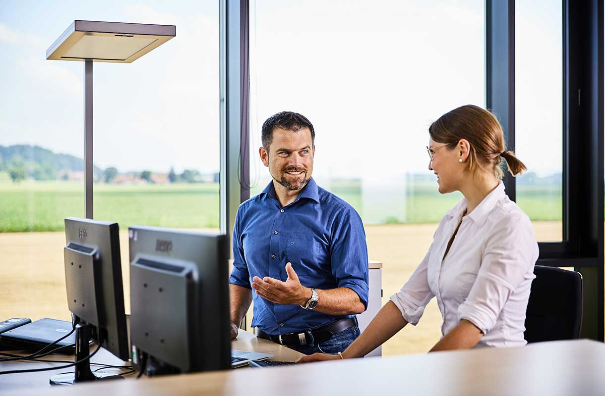 Office Discussion with Computers and Natural Light